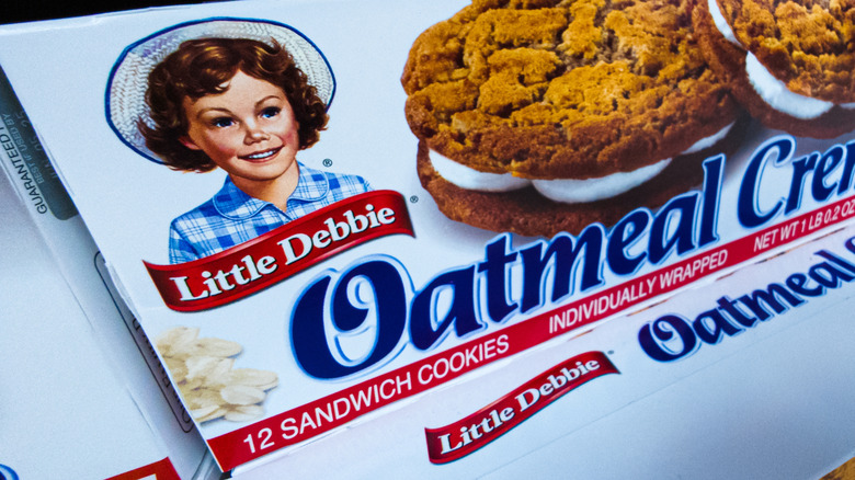Little Debbie smiling on a box of Oatmeal Creme cookies