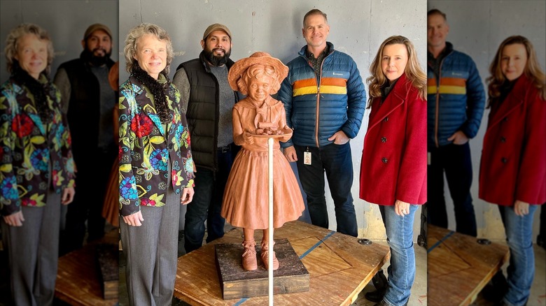 Debbie McKee-Fowler smiling next to her statue