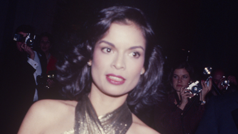 Bianca Jagger wearing a gold lamé dress