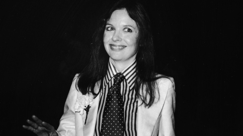 Black and white photo of Diane Keaton wearing a white suit and wide tie