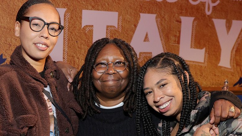 Whoopi Goldberg posing with her granddaughters