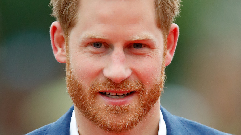 Prince Harry poses for the camera at an event.