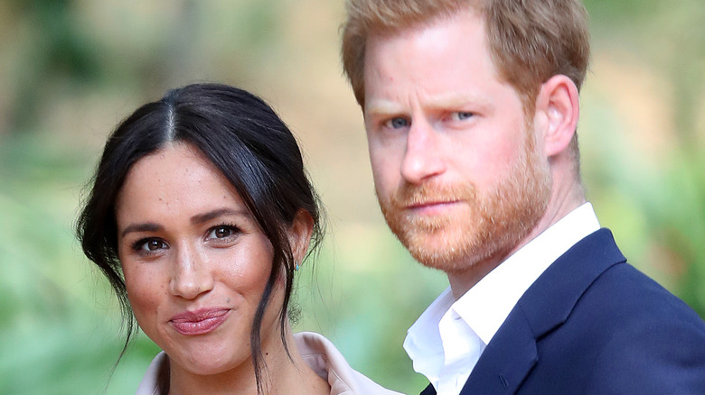 Meghan Markle and Prince Harry pose in a garden