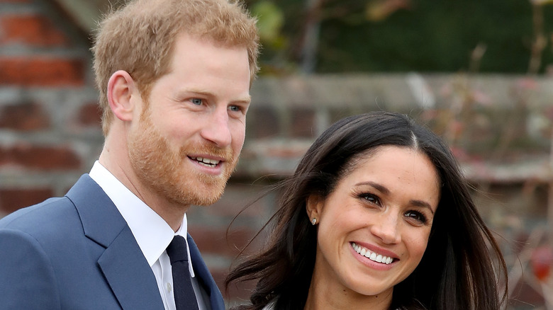 Meghan and Harry smile for photographers