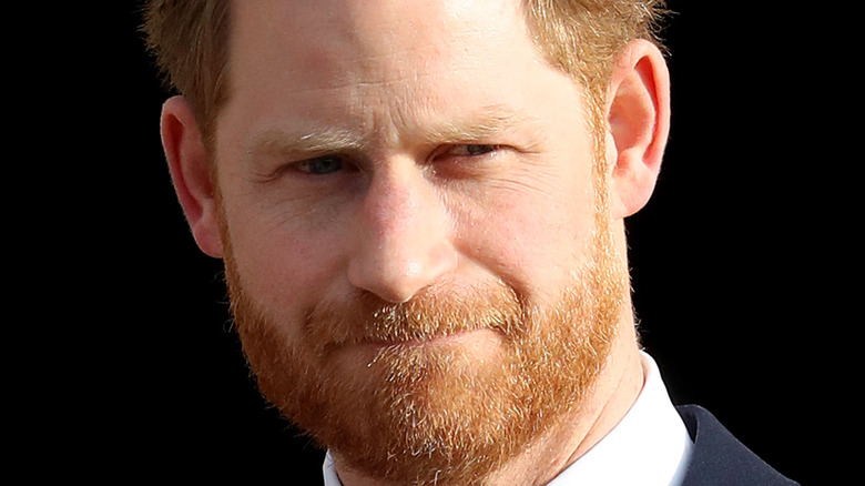 Prince Harry looking solemn queen funeral