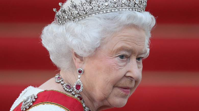 Queen Elizabeth II looks over her shoulder
