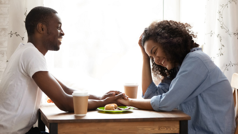 couple flirting at cafe