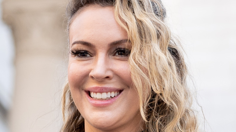 Alyssa Milano smiling at an event