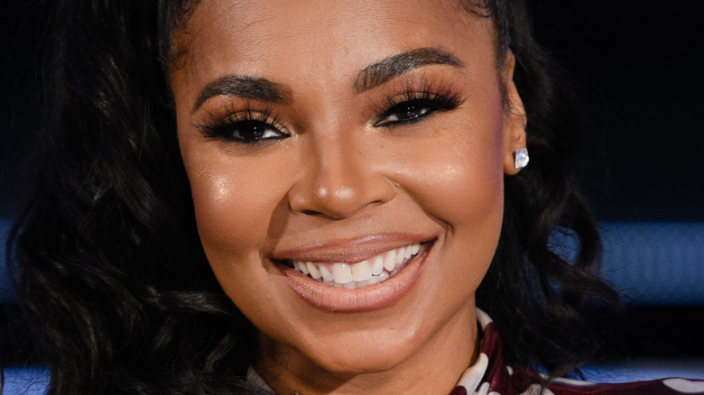 Ashanti smiling on a panel