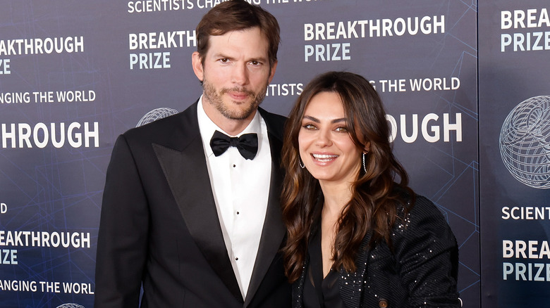 Ashton Kutcher and Mila Kunis posing