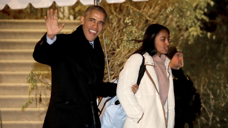 Barack and Sasha Obama walking outside