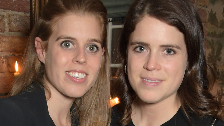 Princess Beatrice and Princess Eugenie posing for a picture