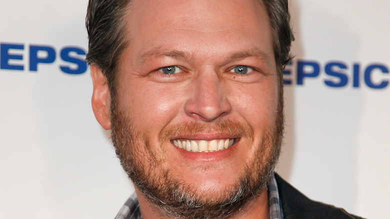 Blake Shelton smiles at an event.