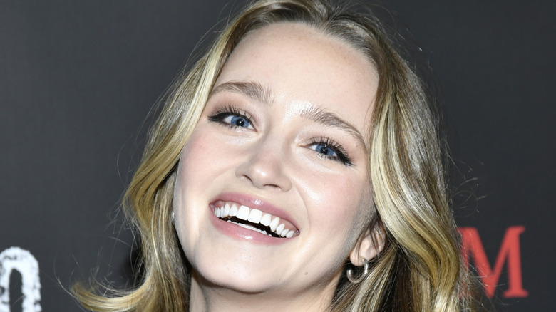 Francesca Xuereb laughing and with her head tilted to the right as she looks at the camera