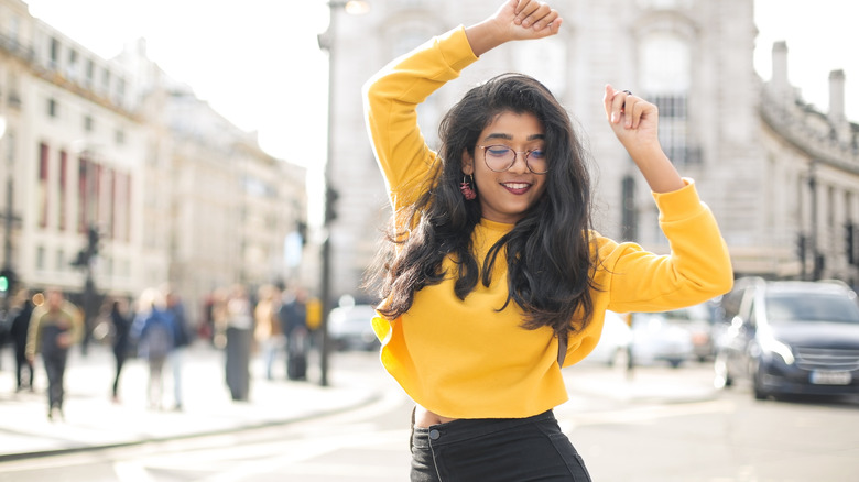 Woman dancing on city street