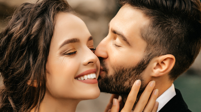 Groom kissing bride's cheek 