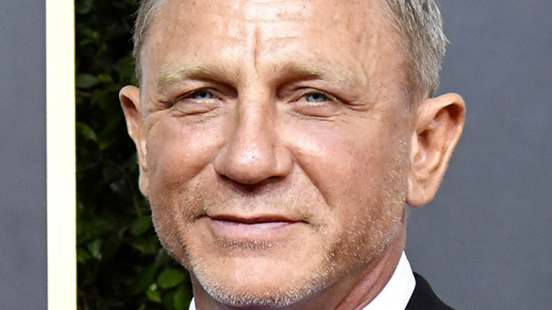 Daniel Craig smiles on the red carpet