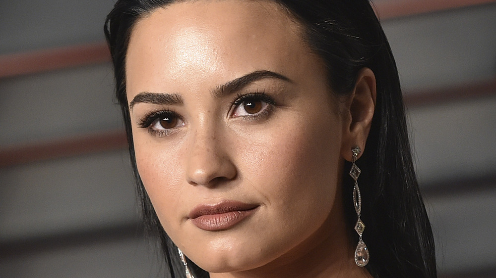 Demi Lovato wearing diamond earrings