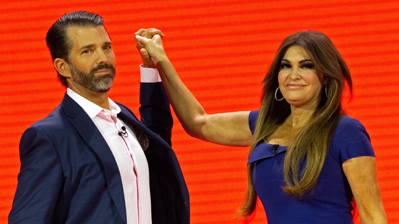 Donald Trump Jr. and Kimberly Guilfoyle clasping hands