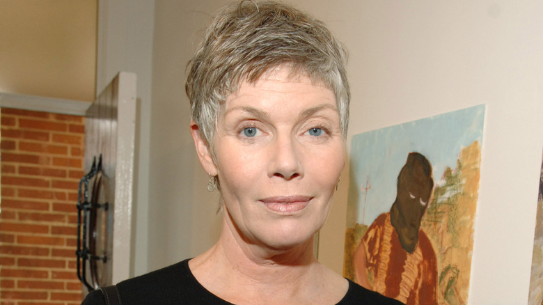 Kelly McGillis slightly smiling while posing at an event