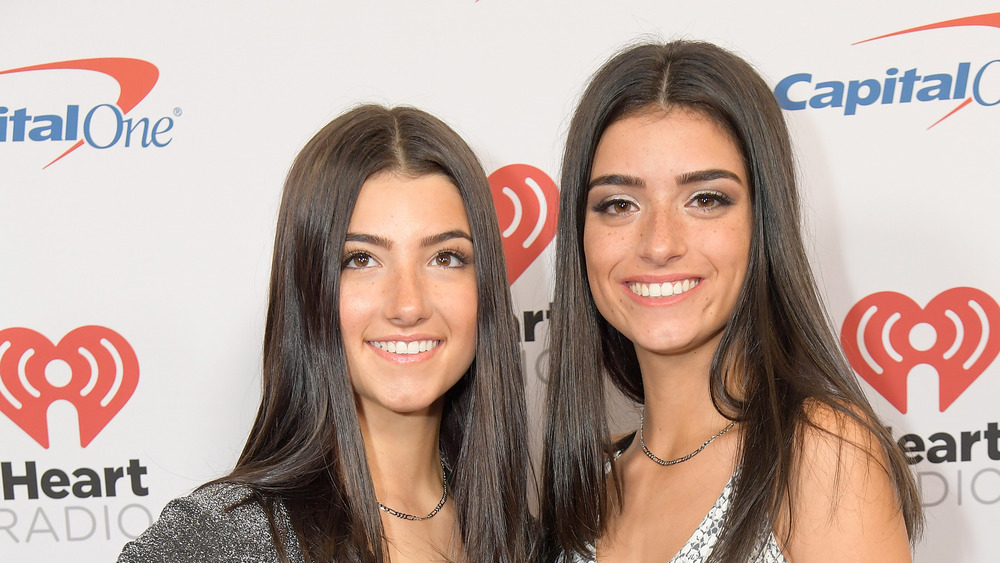 Dixie and Charli D'Amelio smiling at an event