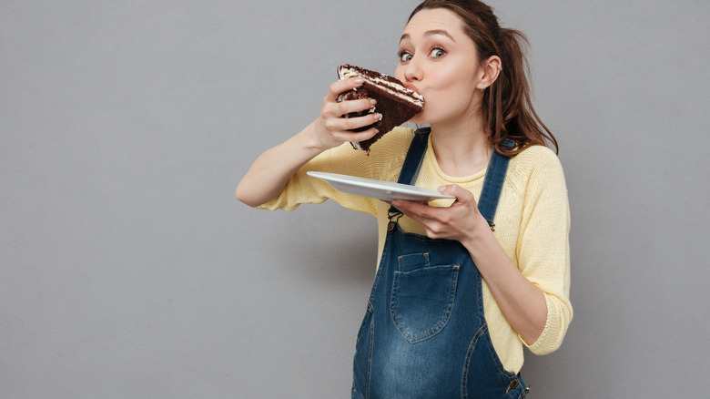 pregnant woman eating chocolate cake
