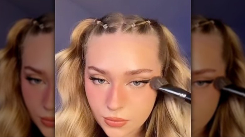 Woman applying blush