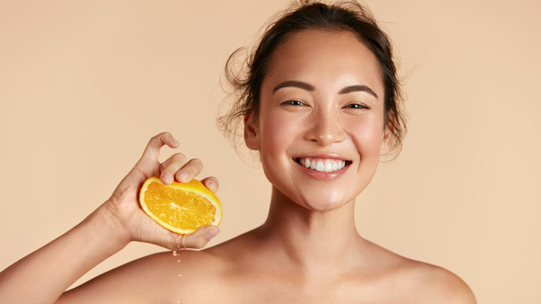 Woman squeezing orange