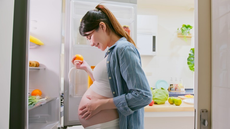 Pregnant woman eating citrus foods