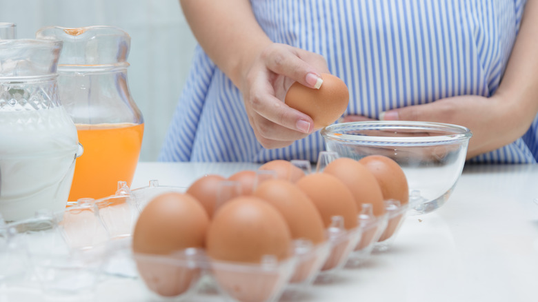 Pregnant Woman Cracking Egg