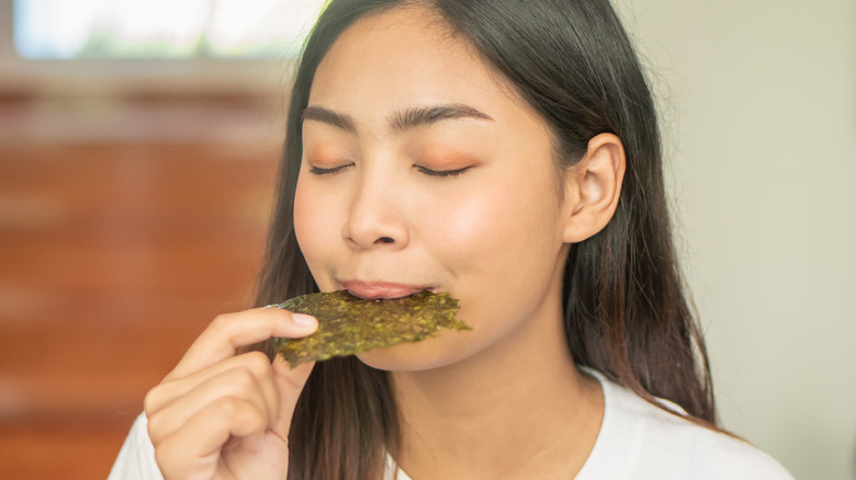 woman eating roasted seaweed