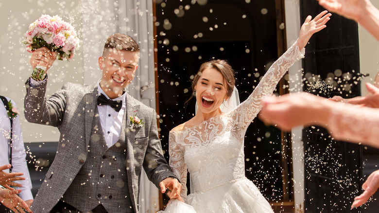 happy bride and groom leaving the wedding venue