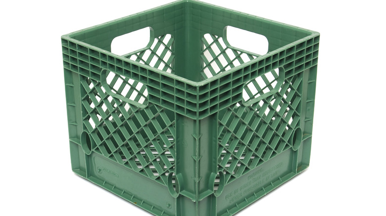 Green plastic milk crate