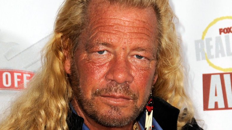 Dog the Bounty Hunter poses at an event