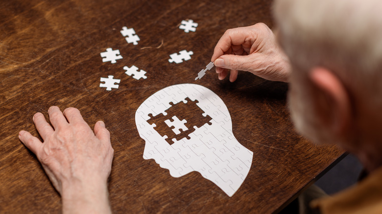 Man putting a puzzle together 