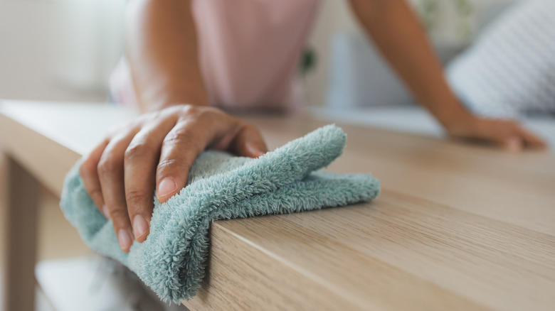 A woman cleaning a table 