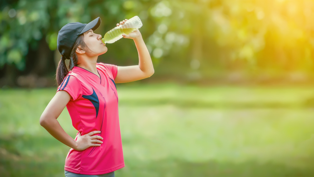 A woman drinking water with electrolytes