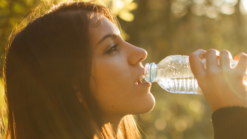 A woman drinking water from bottle