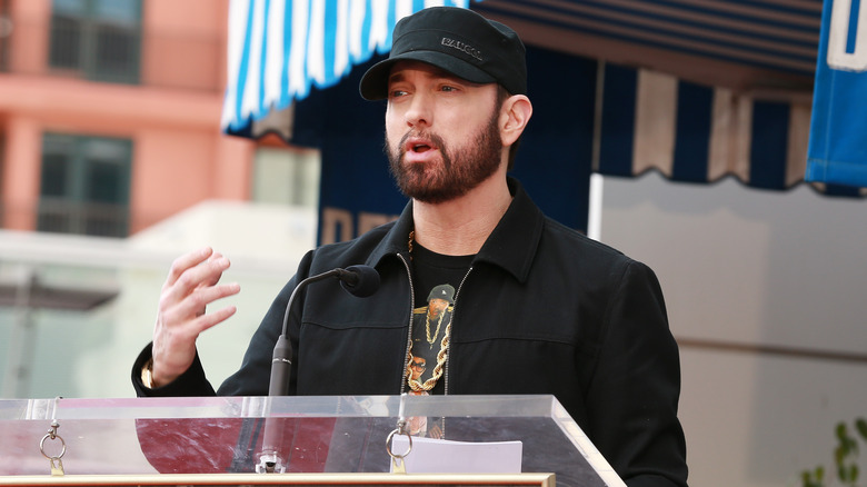 Eminem speaking at podium