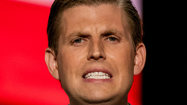 Eric Trump speaking at a podium