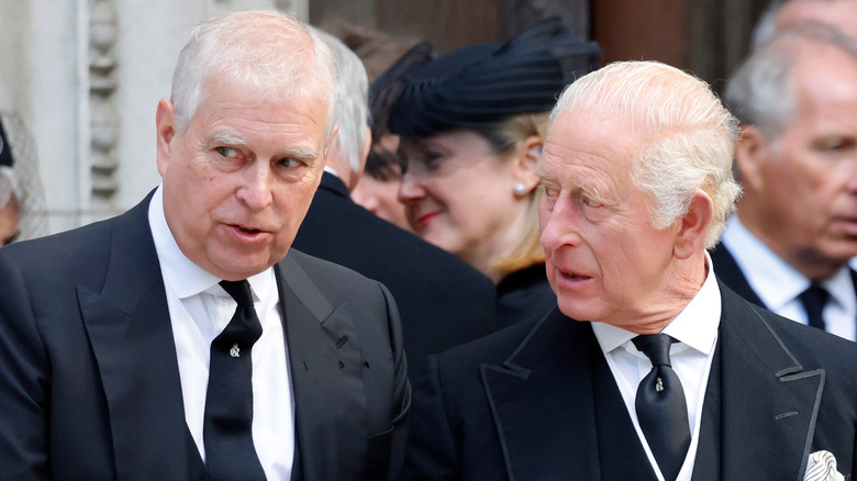 Prince Andrew and King Charles talking together