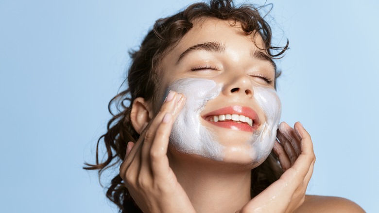 A woman washing her face 