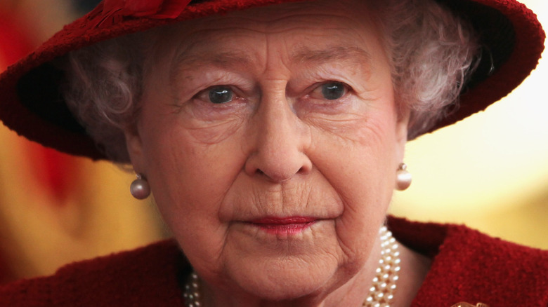 Queen Elizabeth poses in an all-red ensemble