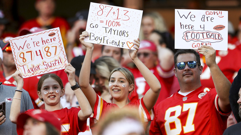 Fans holding Taylor Swift signs KC Chiefs Game