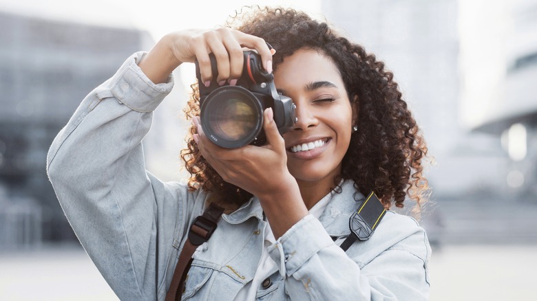 A woman holding a camera