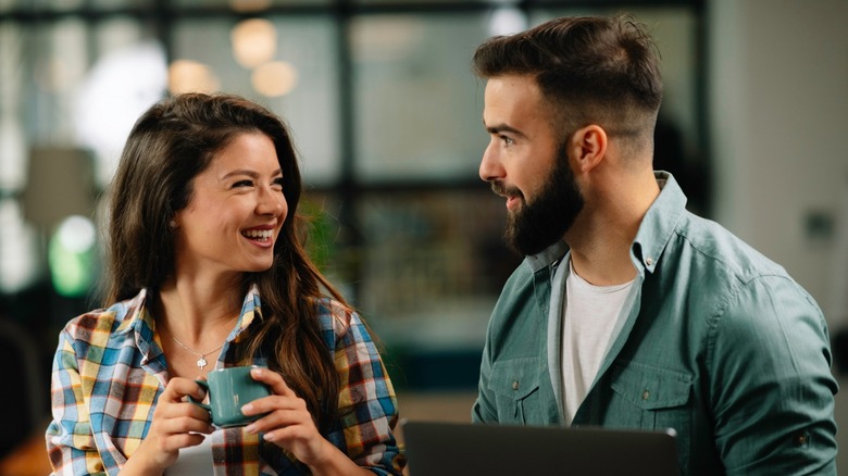 Man and woman smiling at work