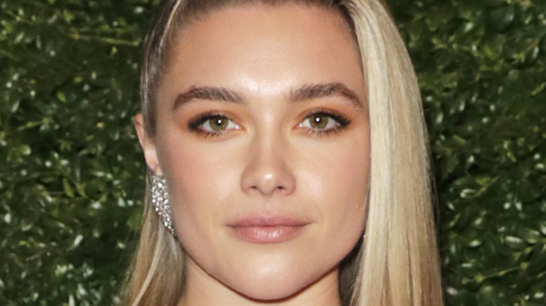 Florence Pugh posing for a picture at an event