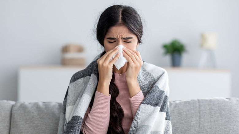 Woman blows her nose