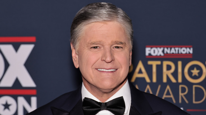 Sean Hannity smiling in a suit and bowtie at Fox Nation's 2024 patriot awards.