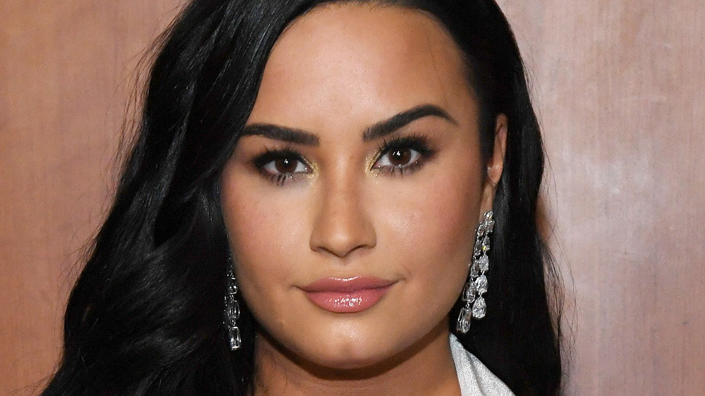 Demi Lovato looking serious with short pink hair